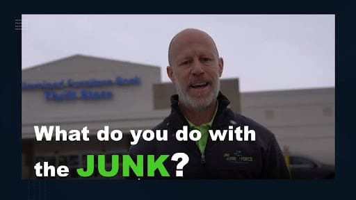 Balding man in green Ohio Junk Force zip-up jacket smiles in front of Huntington Trust Savings Bank building; dark overlay text asks "What do you do with the JUNK?" explaining responsible junk disposal practices.